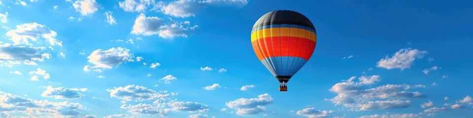Naklejka premium Colorful hot air balloon ascends in blue sky with scattered clouds