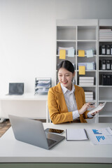 woman meticulously plans a finance audit, using a computer and calculator to review budget...