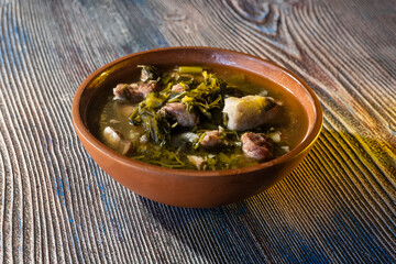 Traditional Georgian food, meat in pot on table top.