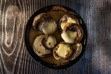 Roasted mushrooms stuffed with cheese and herbs on a table top