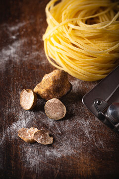 White truffle and fresh pasta Tajarin.  wooden rustic table, magical autumn light. Autumn gourmet cuisine  and truffles recipes of Piedmont, Northern Italy, Spain and France, close up