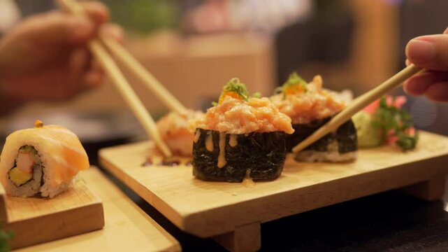 Happy people sharing sushi at restaurant