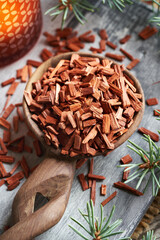 Red sandalwood chips, with an aroma lamp in the background