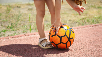 Close-up of a soccer ball in the hand of a female soccer player