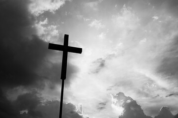 A christian cross under the dark sky