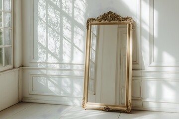 An antique mirror leaning against the wall in a beautiful white room