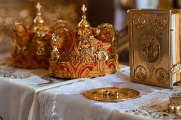 Ornate Wedding Symbols in Golden Elegance with Royal Crowns and Sacred Book on Lace
