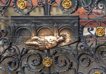 Decorative lattice with John of Nepomuk bronze statue on Charles Bridge. Prague, Czech Republic.
