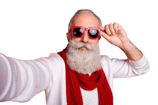 Fashion aged santa man making self photos wear sun specs knitted jumper isolated red background