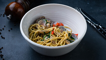 Lunch spaghetti vongole with sweet pepper and greens.