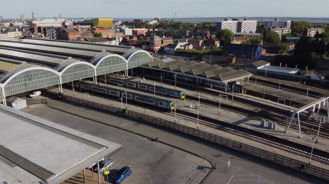 Drone. UK northern train service. Train on tracks.