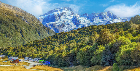 Snow capped peaks of Mount Cook and blue sky with clouds , Mount Cook National Park, New Zealand