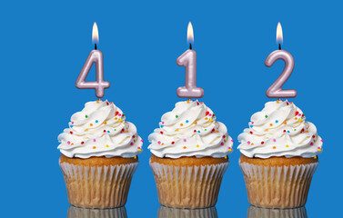 Birthday Cupcakes With Candles Lit Forming The Number 412