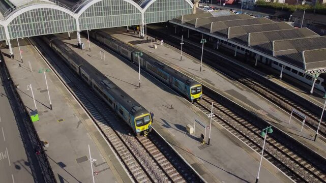 Drone. UK northern train service. Train on tracks.