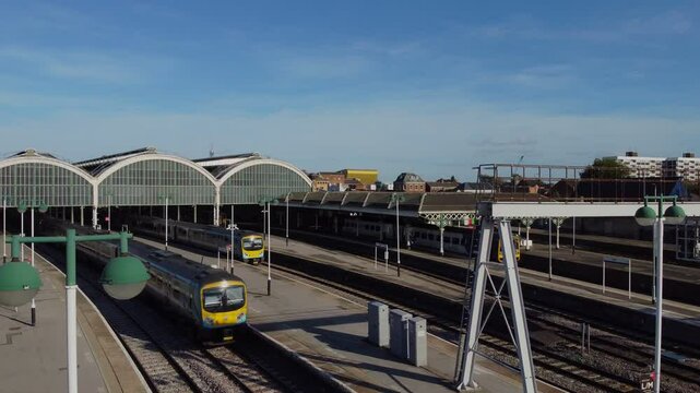 Drone. UK northern train service. Train on tracks.