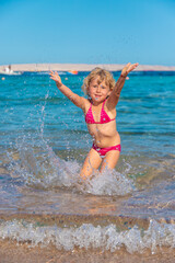 A child bathes and splashes in the sea. Selective focus.