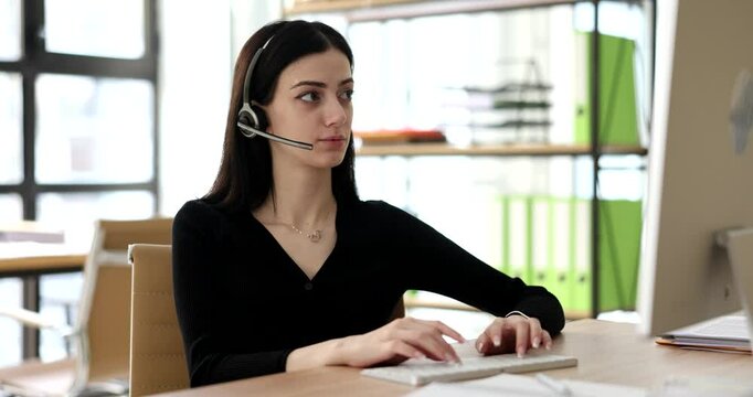 Serious call center operator in wireless headset talking to client. Woman consultant in headphones with microphone consults client on the phone in customer service