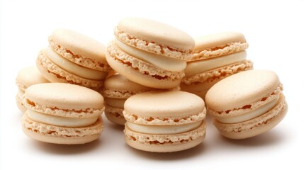 Obraz premium A pile of vanilla-flavored French macarons with smooth cream filling, displayed neatly on a white background.