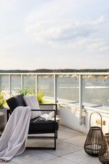 Balcony with water view and comfortable armchair