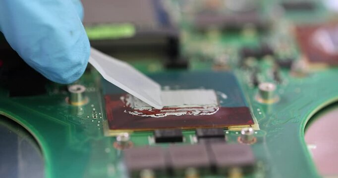 Applying thermal paste to computer central processing unit and repairing computer. Solder paste microcircuit