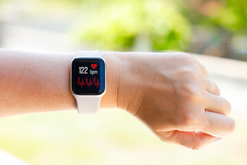 Smart watch health tracker with the heart rate shown on the screen