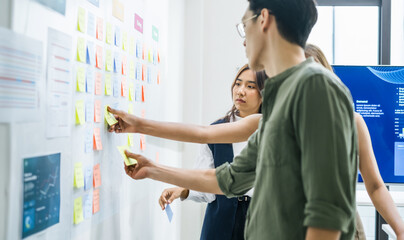 brainstorming session, using sticky notes on a task board (kanban) to organize ideas and workflow...