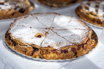Delicious homemade pie with powdered sugar topping, golden crust, and fruit filling, dessert concept