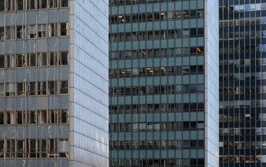 Fototapeta premium Urban architecture showcasing reflective glass buildings in a bustling metropolitan area. Cluster of modern glass buildings in a busy city, showcasing modern architectural styles during daylight hours