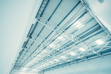 Steel roof structure supporting modern factory ceiling