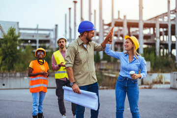 Engineers Celebrating Success at Construction Site with High Five