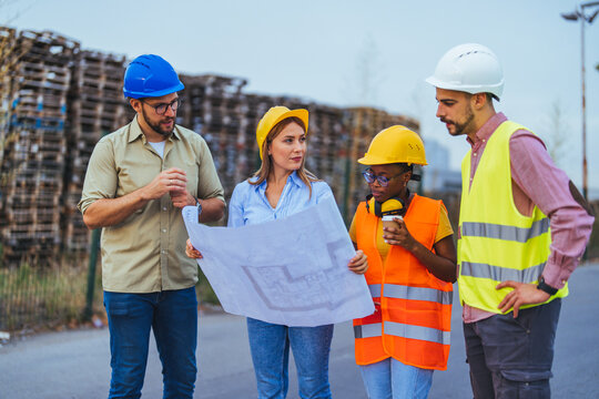Diverse Construction Team Discussing Blueprint at Worksite