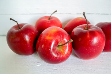 Red apples on a light background. Apple season. Red Chief Apples.