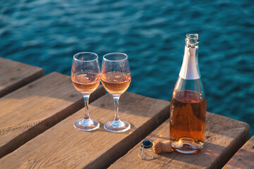 Wine in a glass on the seashore. Selective focus.