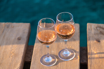 Wine in a glass on the seashore. Selective focus.