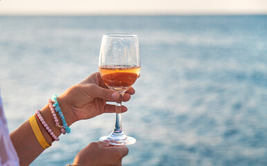 Wine in a glass on the seashore. Selective focus.