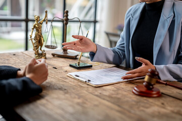 Lawyer explaining contract and offering agreement to client in office