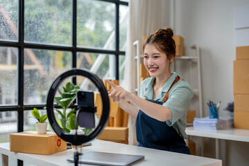 A woman is pointing at a camera on a table