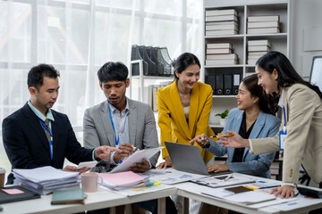 A group of people are sitting around a table in a business setting