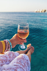 Wine in a glass on the seashore. Selective focus.