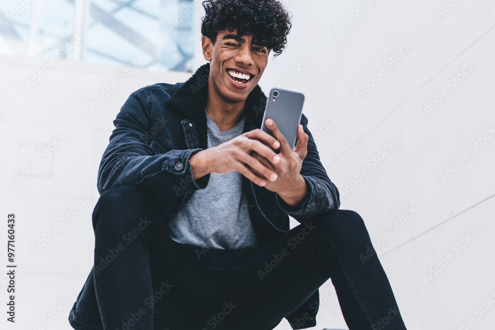Poster latino hipster guy rejoicing at urban setting happy from received good comments and reviews for own 