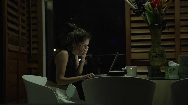 Tired Remote worker digital nomad female working late at night from home