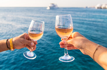 Wine in a glass on the seashore. Selective focus.