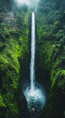 Tall waterfall cascading down lush green cliffs