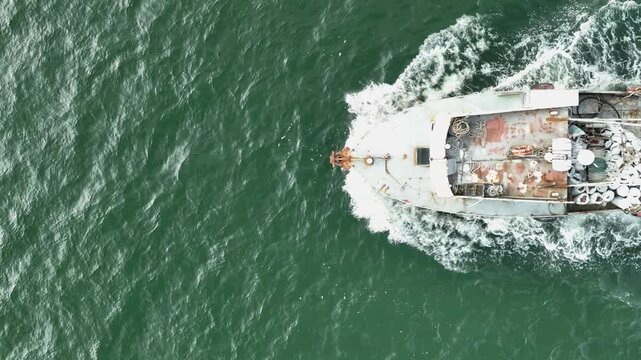 Aerial view of trawler vessel. Fishing boat trauler with sacks full of rapani