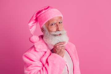 Photo of eccentric uncertain unsure senior man wear stylish bright bathrobe touch beard isolated on pink color background
