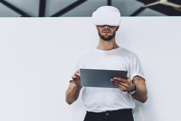 Skilled man typing with digital pencil for interactive touch over tablet for creating augmented 3d...
