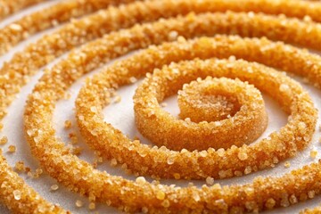 Fototapeta premium Golden-brown sugar crystals scattered around a delicate, swirly pattern of sütlaç, showcasing its smooth, velvety texture on a pure white surface