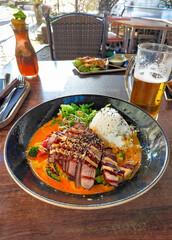 Grilled Meat with Rice and Beer in a Restaurant Setting