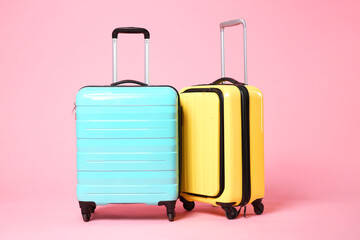 Two new color suitcases on pink background