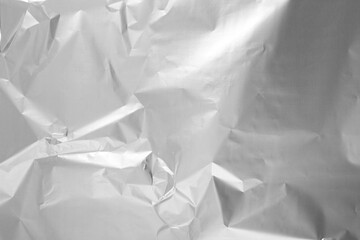 Shiny silver tinfoil surface as background, top view